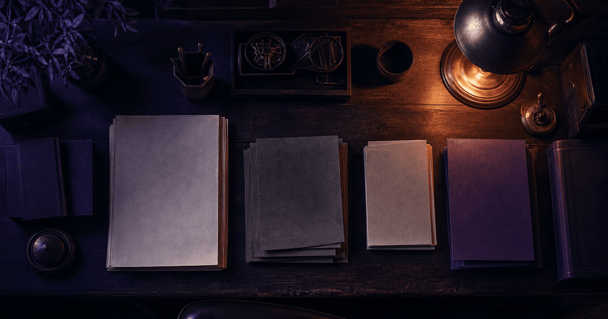 Stacks of paper neatly separated on a writing desk under a single warm lamp in deep shadow